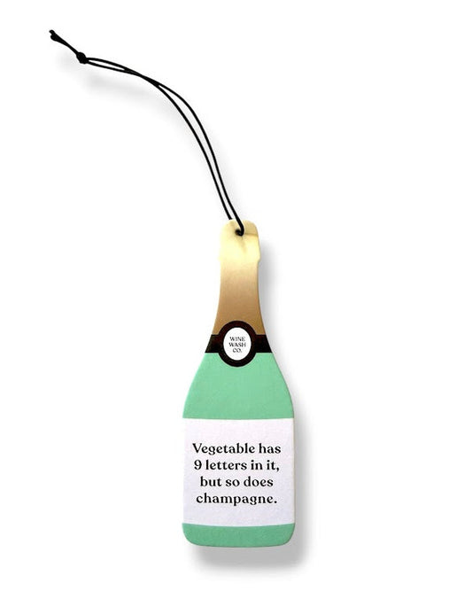 Green champagne bottle-shaped air freshener with a humorous message on a white background