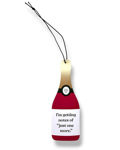 wine bottle-shaped air freshener with funny saying on a white background for red wine lovers