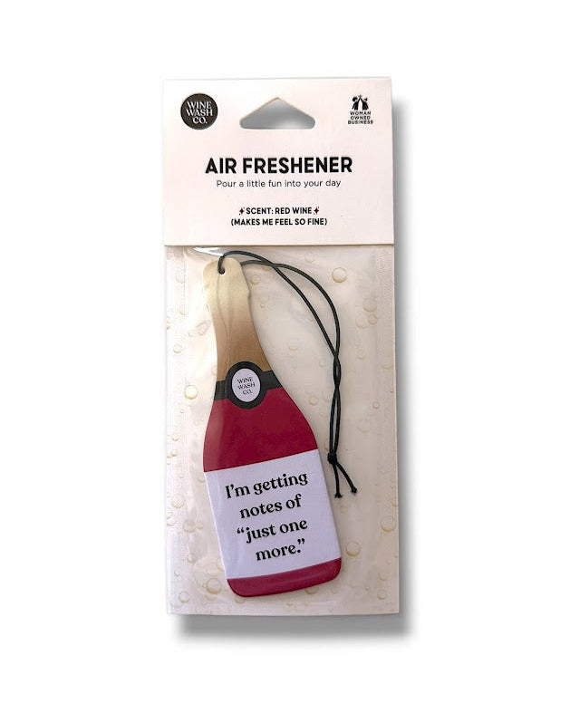 Air freshener shaped like a bottle of red wine with humorous text on a white background