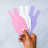 biodegradable pop up eco-friendly sponges in pink purple white. shaped like wine bottles for a pop of fun in your kitchen sink.