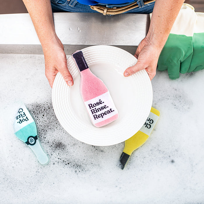 When the bottle is empty, keep your spirits up and your kitchen clean with this fun (and effective) household sponge. A scour pad lines the bottom for those extra tough spots. Sponge is approximately 7.25 x 2.5 x 1.25". Includes (1) pink rosé "Rosé Rinse Repeat" sponge.  Makes for a great gift for the rose or wine lover in your life. When you shop with Wine Wash Co. you are supporting a small, woman-owned business!